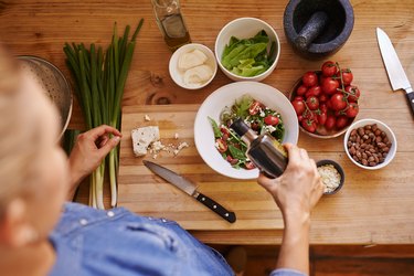 overhead view of a person making a high-protein salad with healthy ingredients