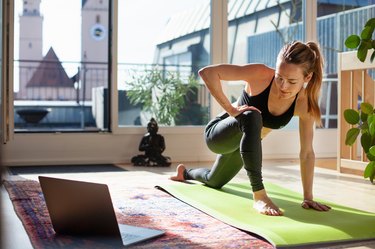 Woman exercising at home, as a way to get rid of period cramps