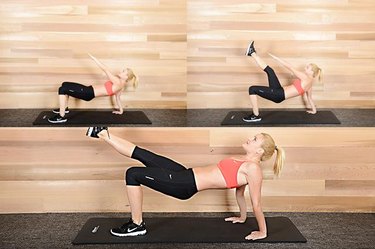 Woman performing tripod crab hip lift ab exercise.
