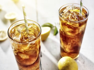 two ice cold glasses of iced tea with lemons